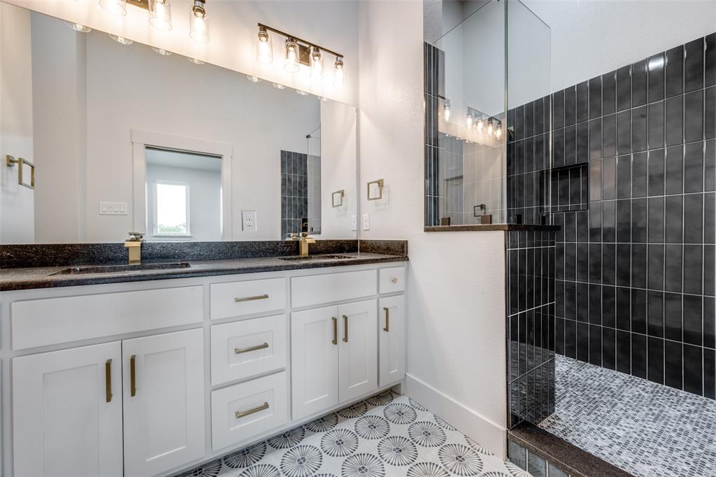 614 Twin Hills Road Lake Bridgeport, TX 76426 - Photo 24 of 25 a bathroom with a granite countertop sink a mirror and a shower