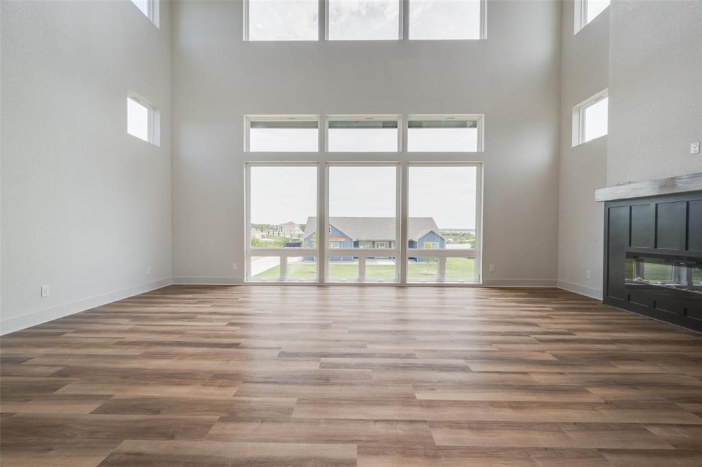 614 Twin Hills Road Lake Bridgeport, TX 76426 - Photo 8 of 25 a view of an empty room with wooden floor and a window