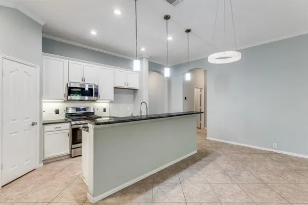 a kitchen with stainless steel appliances granite countertop a stove a sink a refrigerator and a oven