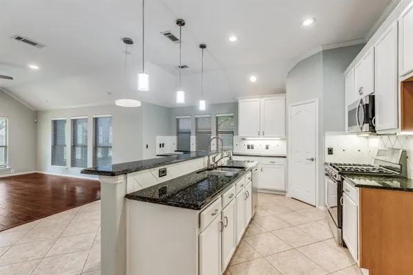a kitchen with a stove sink and a refrigerator