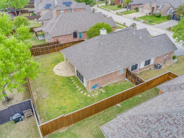 an aerial view of a house with a yard