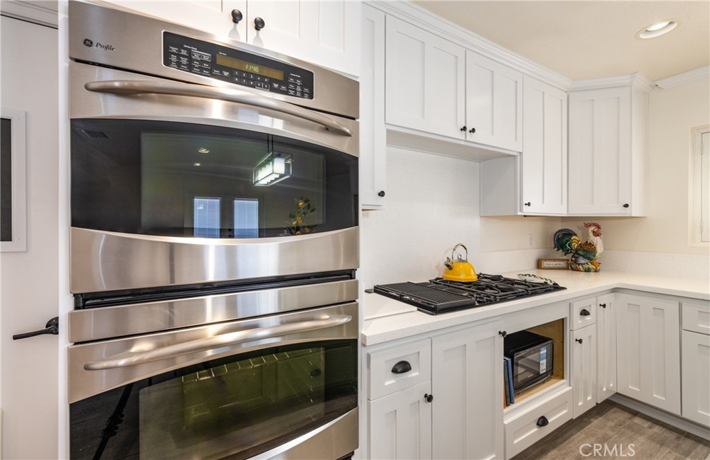 12780 Blossom Avenue Yucaipa, CA 92399 - Photo 11 of 31 a kitchen with granite countertop stainless steel appliances and white cabinets