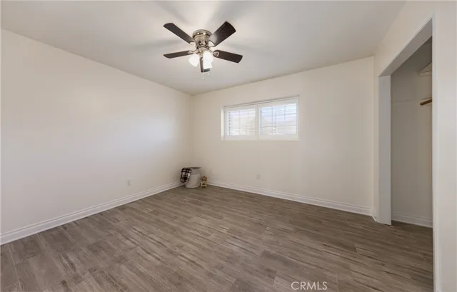 a bedroom with furniture and a wooden floor
