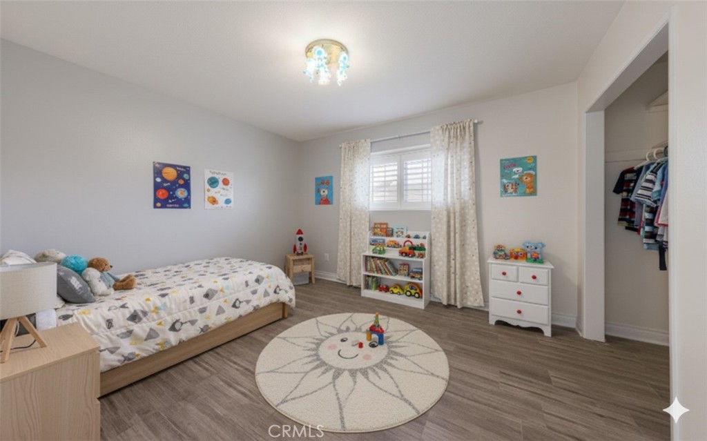 12780 Blossom Avenue Yucaipa, CA 92399 - Photo 16 of 31 a bedroom with furniture and a wooden floor