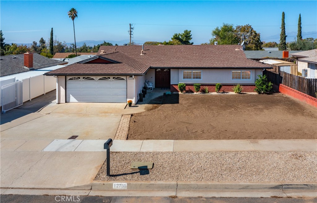 12780 Blossom Avenue Yucaipa, CA 92399 - Photo 2 of 31 a front view of a house with a yard