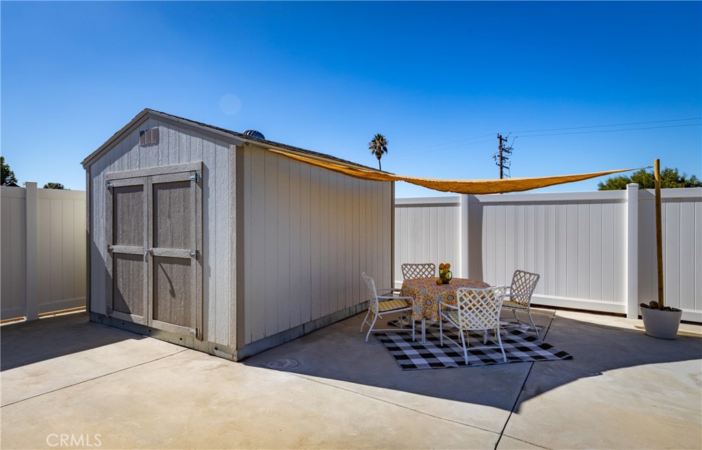 12780 Blossom Avenue Yucaipa, CA 92399 - Photo 22 of 31 a patio with table and chairs and potted plants