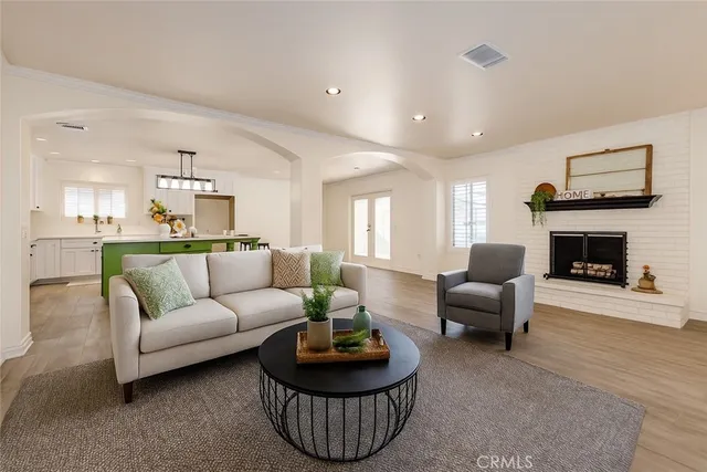 a living room with furniture a rug and a fireplace