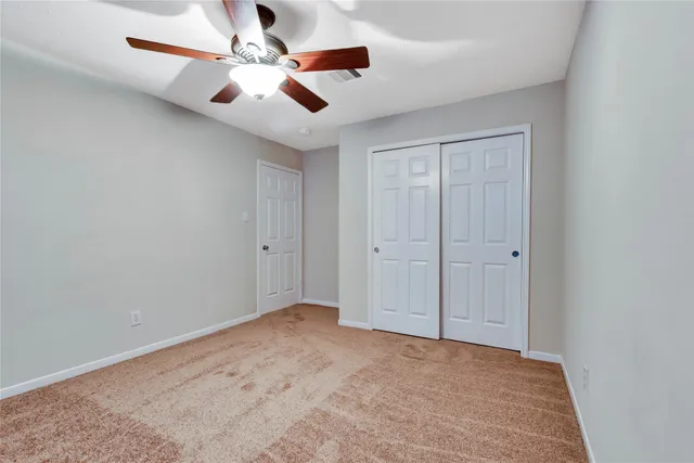 a view of a house with a yard and fence