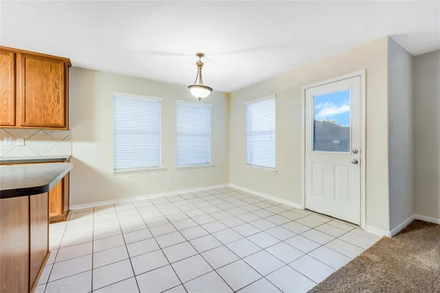 a kitchen with stainless steel appliances granite countertop a stove a sink dishwasher and a refrigerator