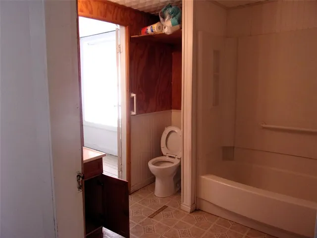 a bathroom with a toilet and a bathtub