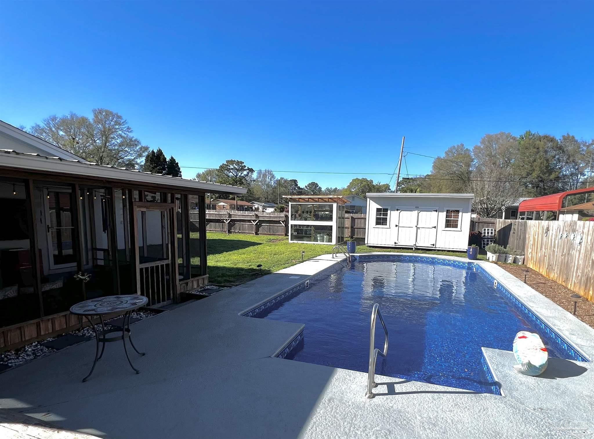 a view of a swimming pool with a lounge chair