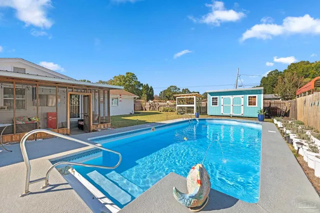 a view of swimming pool with seating area