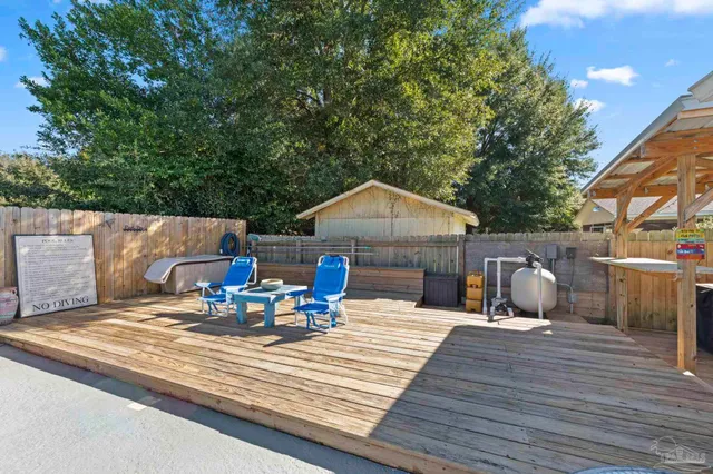 a view of house with deck outdoor seating and yard