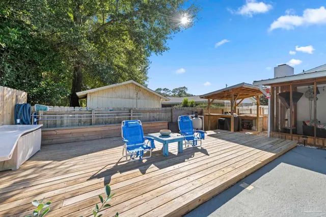 a view of a patio with table and chairs and wooden floor