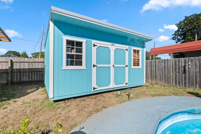 a view of a house with swimming pool and sitting area