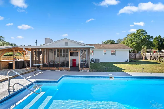 a view of a house with swimming pool and sitting area