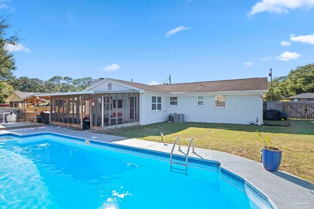 a view of a patio with couches table and chairs with wooden floor