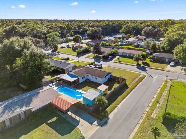 an aerial view of residential houses with outdoor space