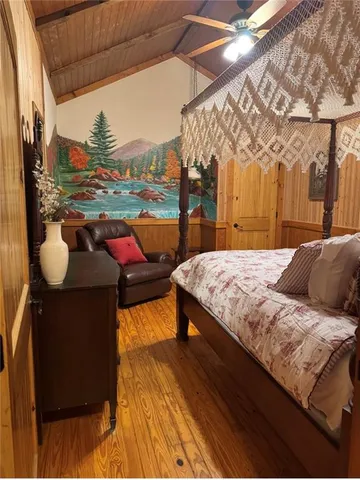 a bedroom with a bed and a night stand