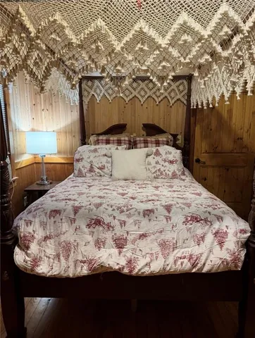 a bed sitting in a bedroom next to a yard