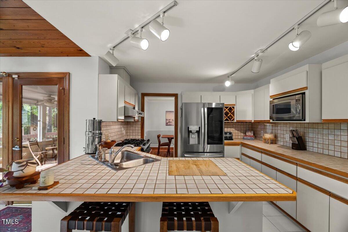 6117 Dodsworth Drive Raleigh, NC 27612 - Photo 13 of 54 a large kitchen with lots of counter space and furniture