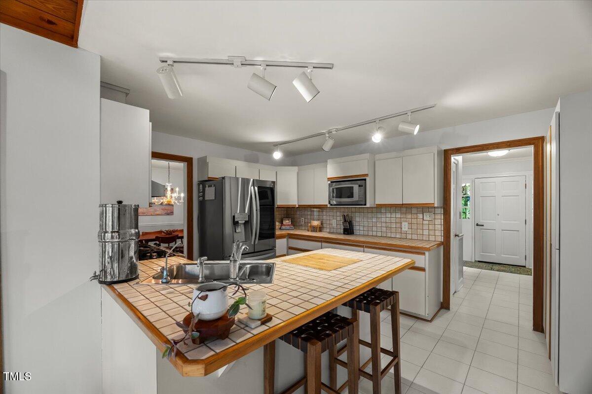 6117 Dodsworth Drive Raleigh, NC 27612 - Photo 14 of 54 a view of a dining room with furniture