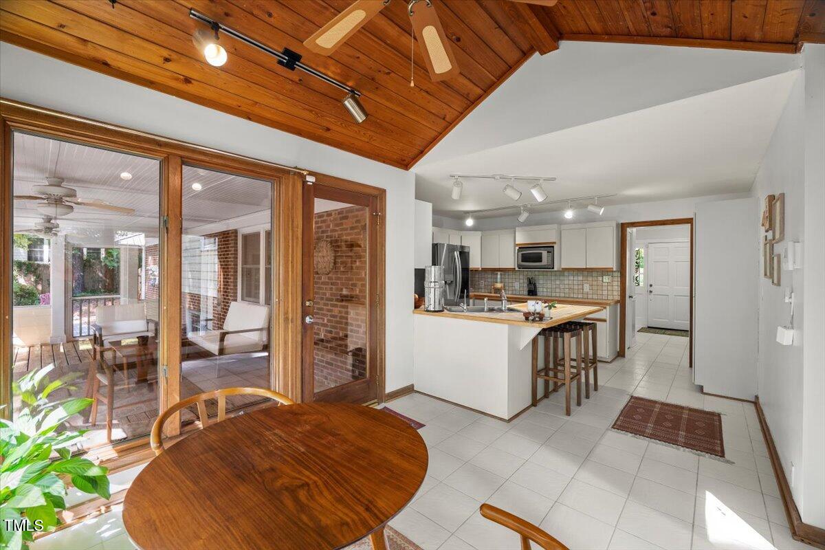 6117 Dodsworth Drive Raleigh, NC 27612 - Photo 18 of 54 a large white kitchen with a large window and stainless steel appliances