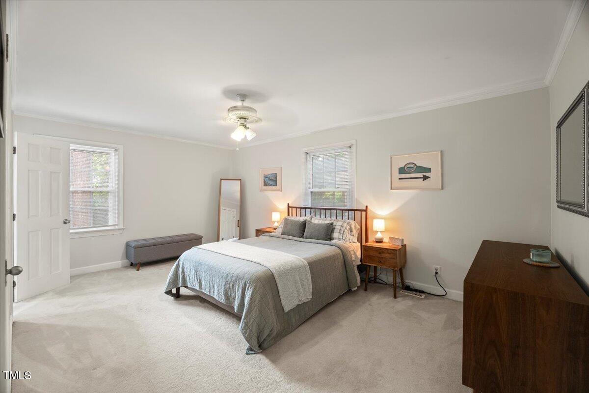 6117 Dodsworth Drive Raleigh, NC 27612 - Photo 21 of 54 a bedroom with a bed and a chandelier