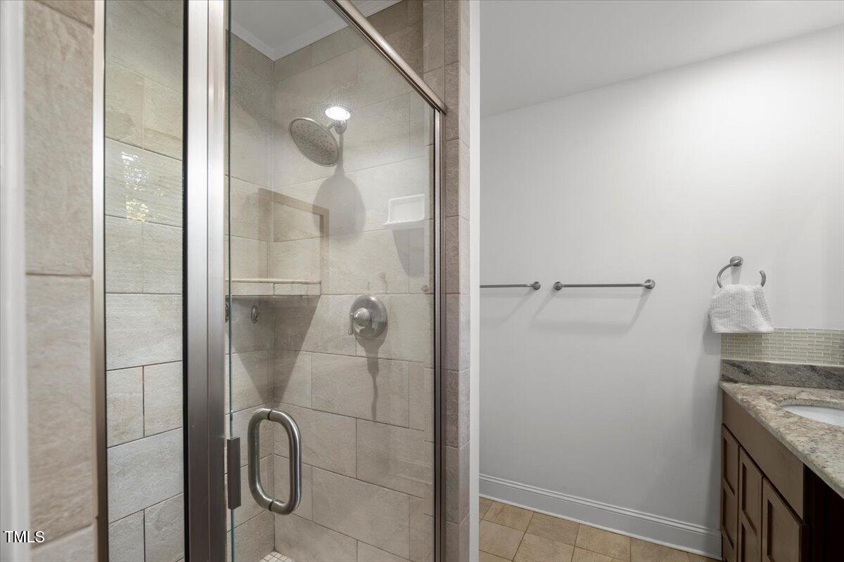 6117 Dodsworth Drive Raleigh, NC 27612 - Photo 24 of 54 a bathroom with a granite countertop shower and a mirror