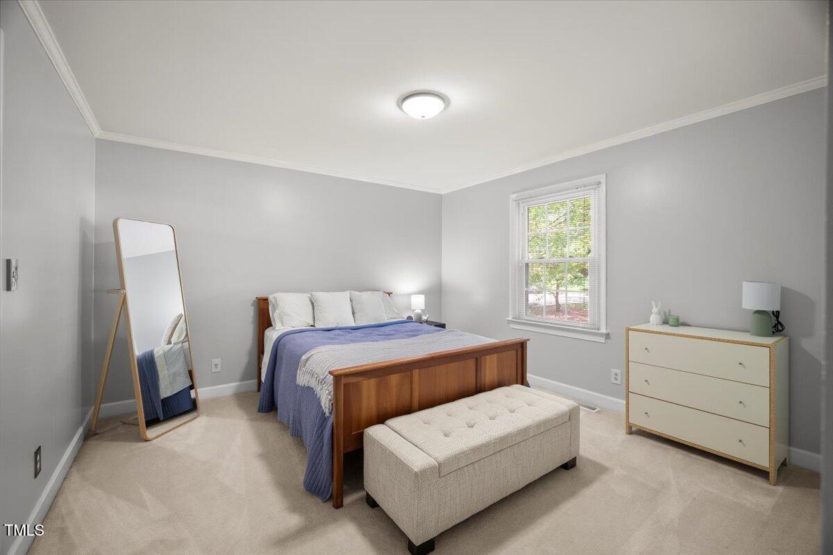 6117 Dodsworth Drive Raleigh, NC 27612 - Photo 28 of 54 a bedroom with a bed and window
