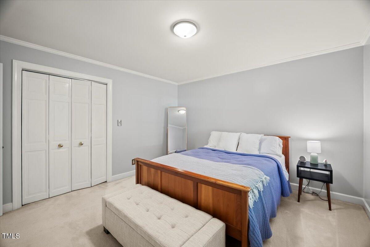 6117 Dodsworth Drive Raleigh, NC 27612 - Photo 29 of 54 a bedroom with a bed and a table