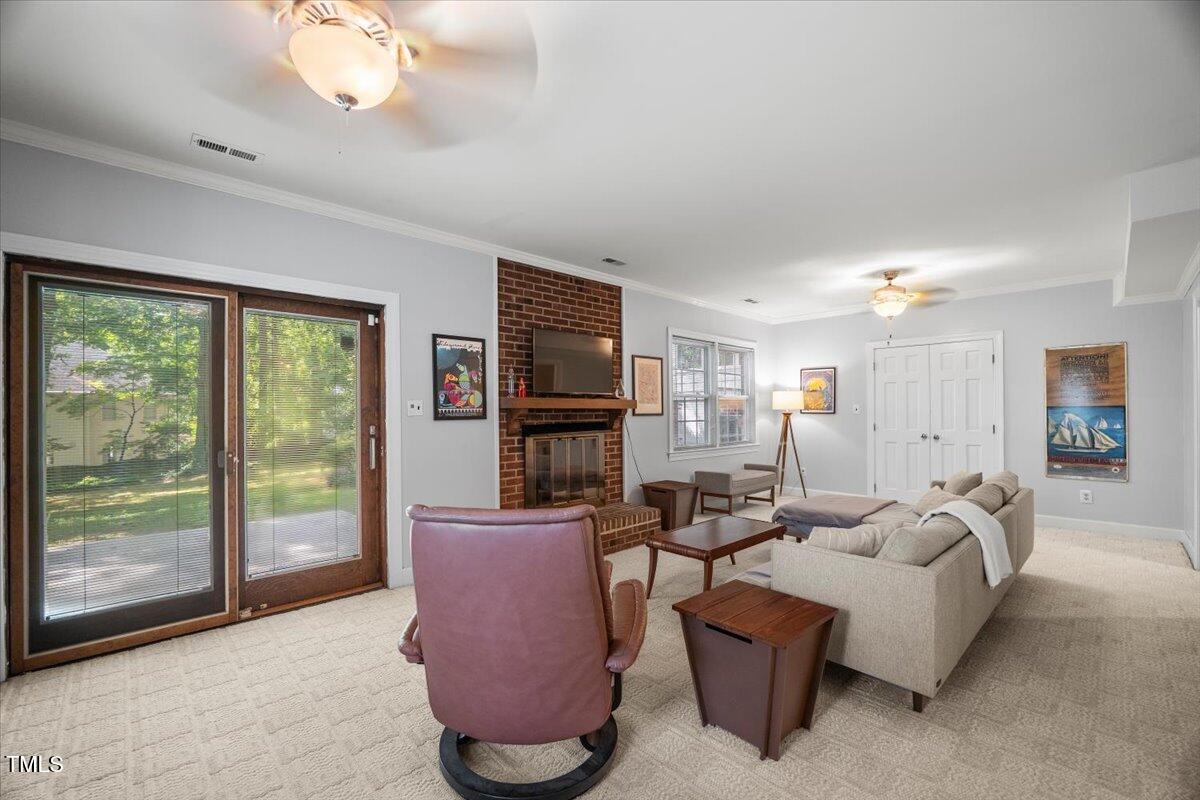 6117 Dodsworth Drive Raleigh, NC 27612 - Photo 33 of 54 a living room with furniture a flat screen tv and a large window