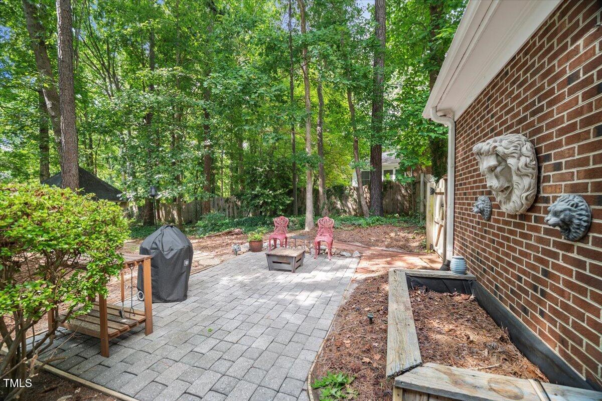 6117 Dodsworth Drive Raleigh, NC 27612 - Photo 41 of 54 a view of a patio with table and chairs and potted plants