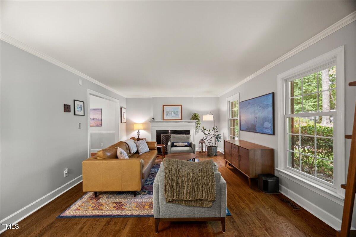 6117 Dodsworth Drive Raleigh, NC 27612 - Photo 6 of 54 a living room with furniture and a flat screen tv