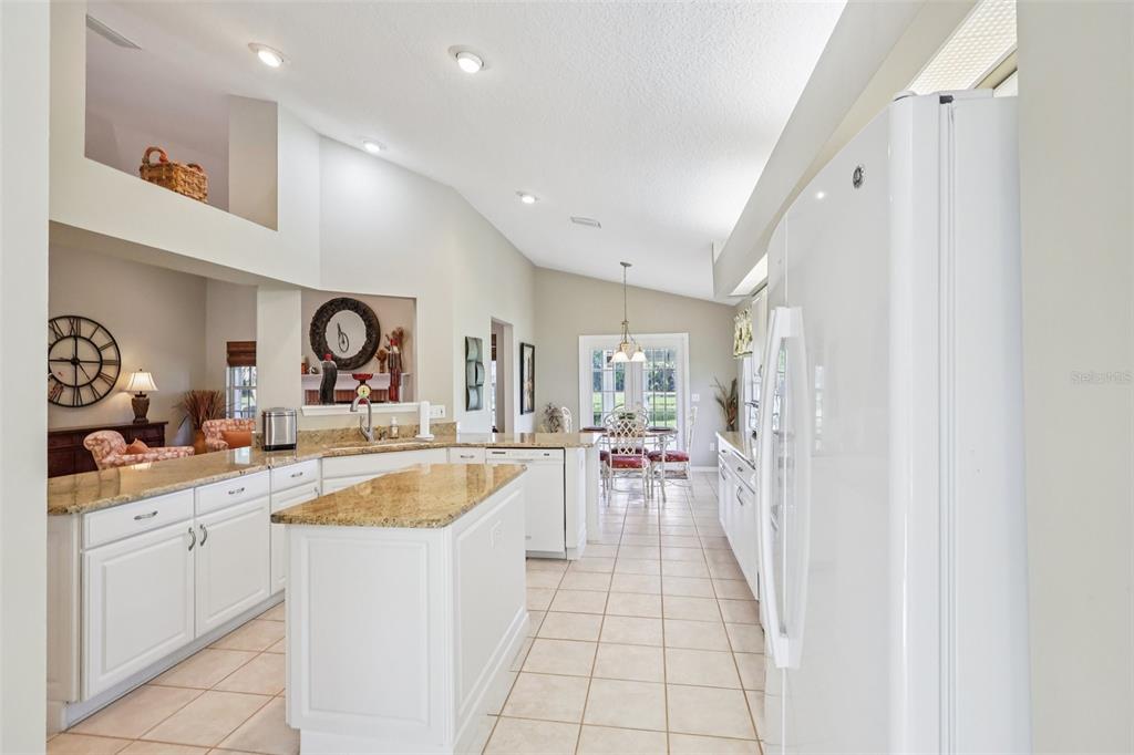 587 Juniper Way Tavares, FL 32778 - Photo 12 of 56 a kitchen with a sink and a stove top oven