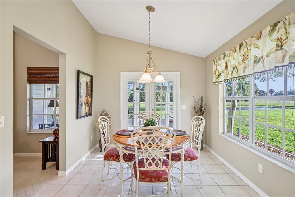 587 Juniper Way Tavares, FL 32778 - Photo 13 of 56 a dining room with furniture a chandelier and window