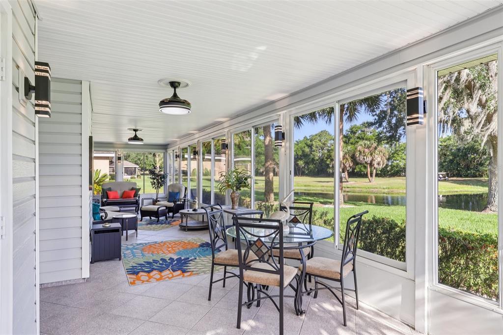587 Juniper Way Tavares, FL 32778 - Photo 15 of 56 a living room with patio furniture and a floor to ceiling window