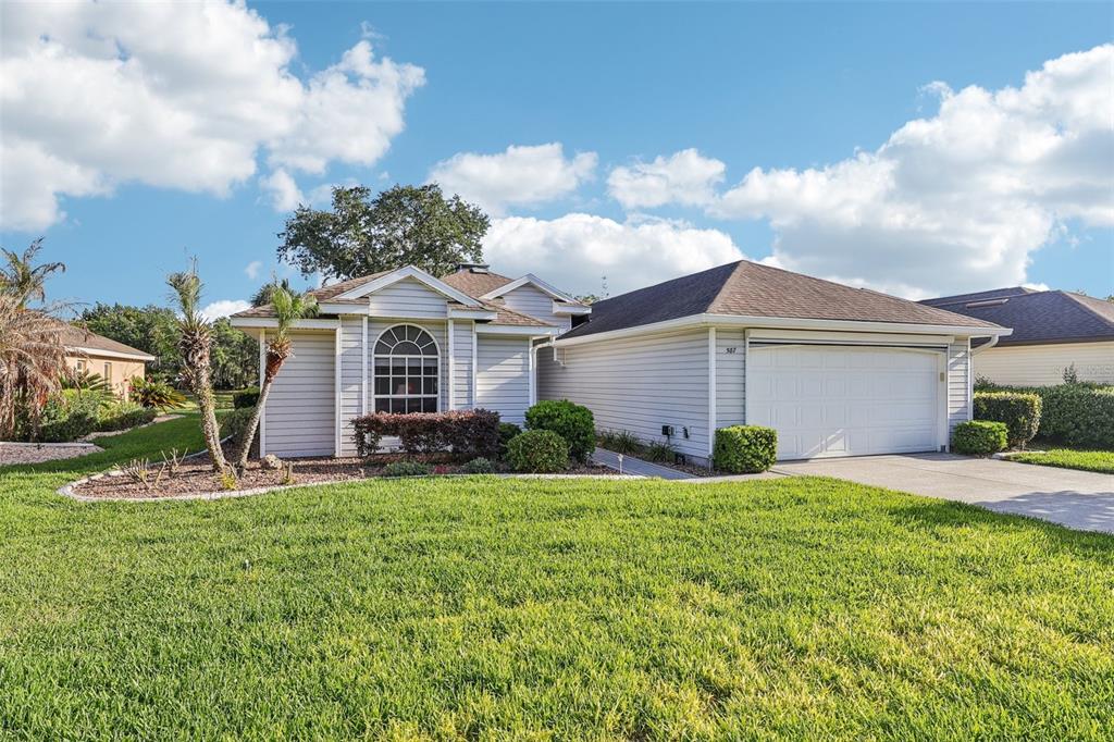 587 Juniper Way Tavares, FL 32778 - Photo 2 of 56 front view of a house with a yard