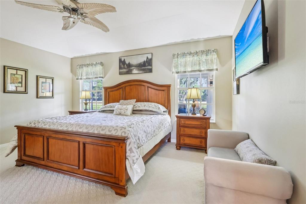 587 Juniper Way Tavares, FL 32778 - Photo 24 of 56 a bedroom with a bed and ceiling fan