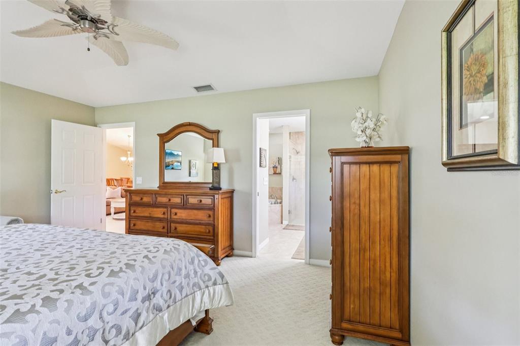 587 Juniper Way Tavares, FL 32778 - Photo 26 of 56 a bedroom with a bed and a dresser