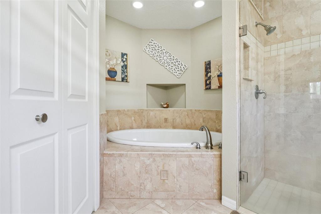 587 Juniper Way Tavares, FL 32778 - Photo 28 of 56 a bathroom with a bathtub and a shower