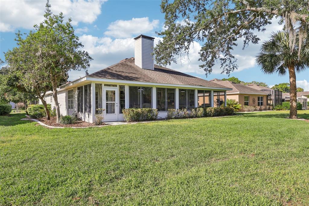 587 Juniper Way Tavares, FL 32778 - Photo 34 of 56 a front view of a house with a garden