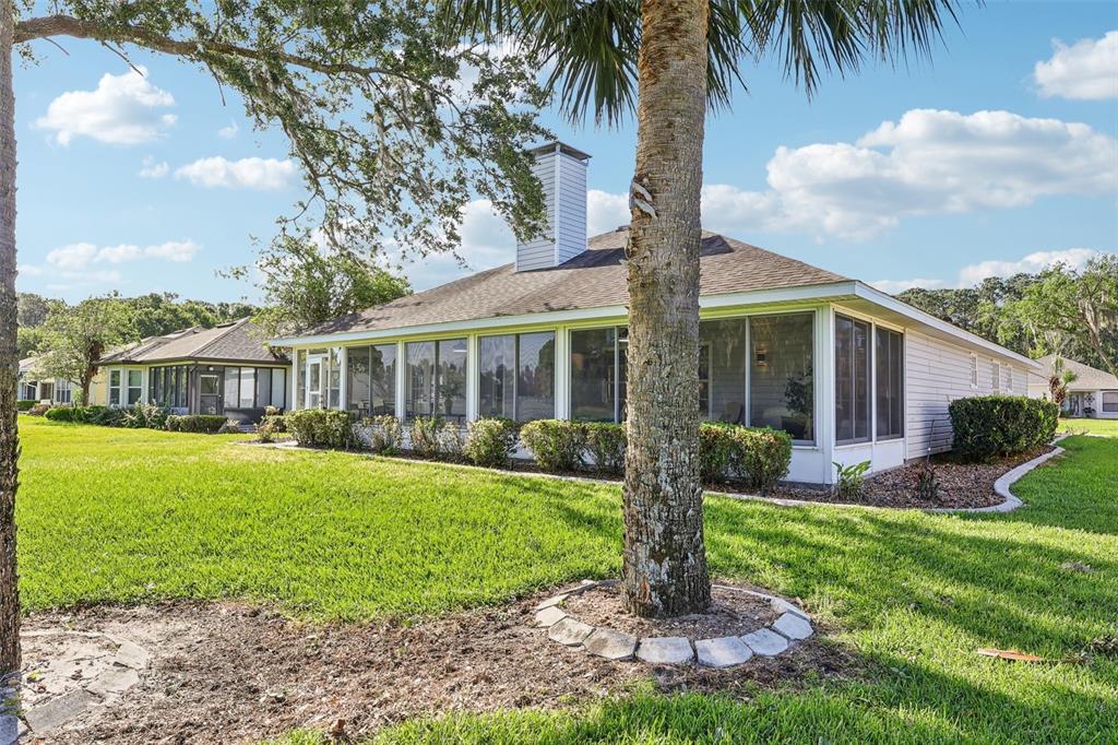 587 Juniper Way Tavares, FL 32778 - Photo 35 of 56 a front view of house with yard and porch