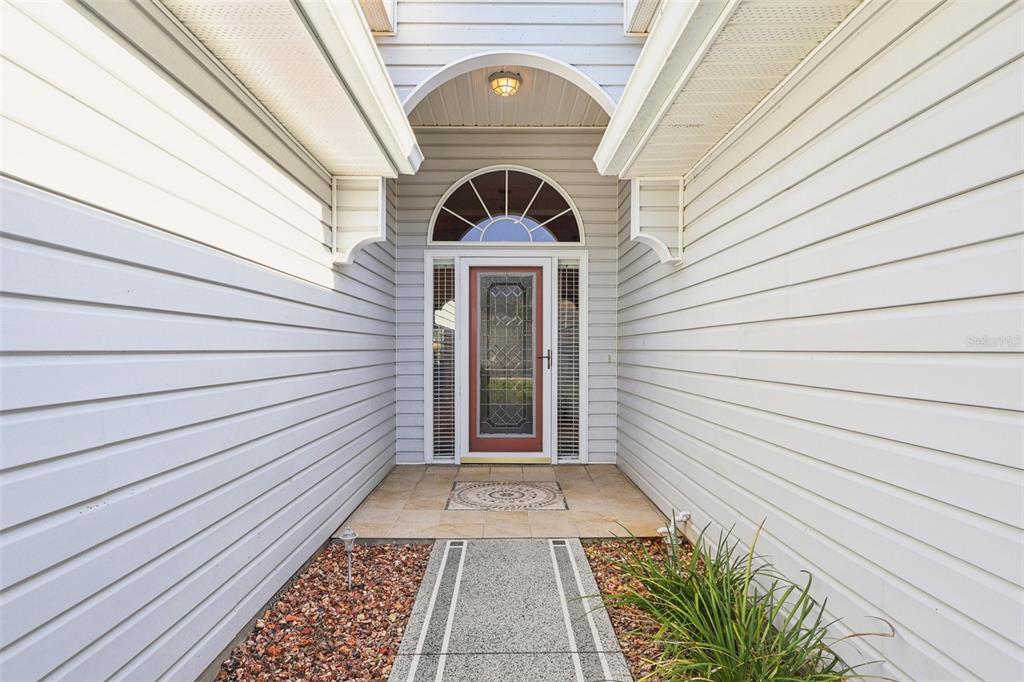 587 Juniper Way Tavares, FL 32778 - Photo 4 of 56 a view of a pathway with a white house