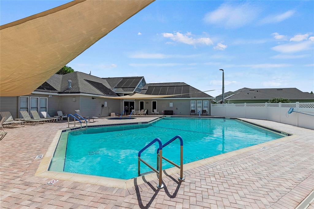 587 Juniper Way Tavares, FL 32778 - Photo 43 of 56 a view of a swimming pool with a lounge chair