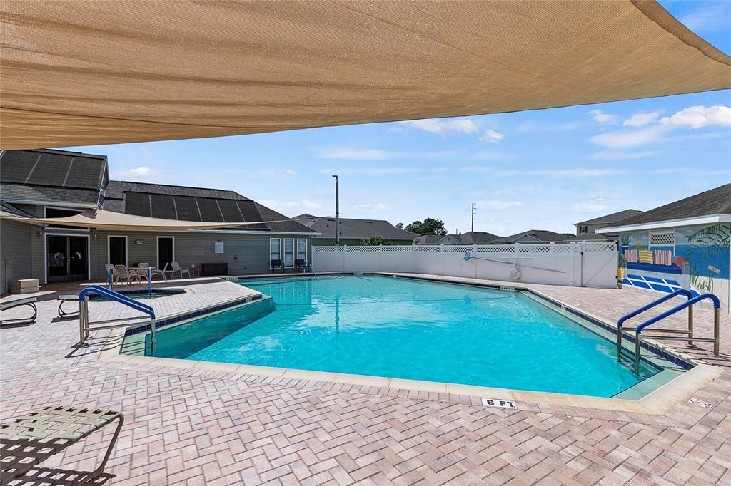 587 Juniper Way Tavares, FL 32778 - Photo 44 of 56 a view of a swimming pool with lounge chairs