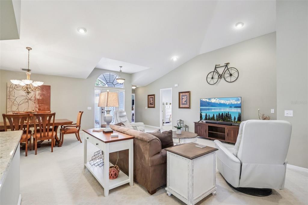 587 Juniper Way Tavares, FL 32778 - Photo 5 of 56 a living room with furniture and a table