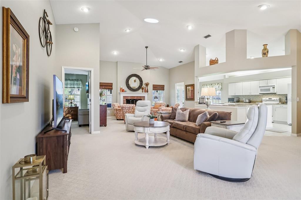 587 Juniper Way Tavares, FL 32778 - Photo 6 of 56 a living room with fireplace furniture and a large window