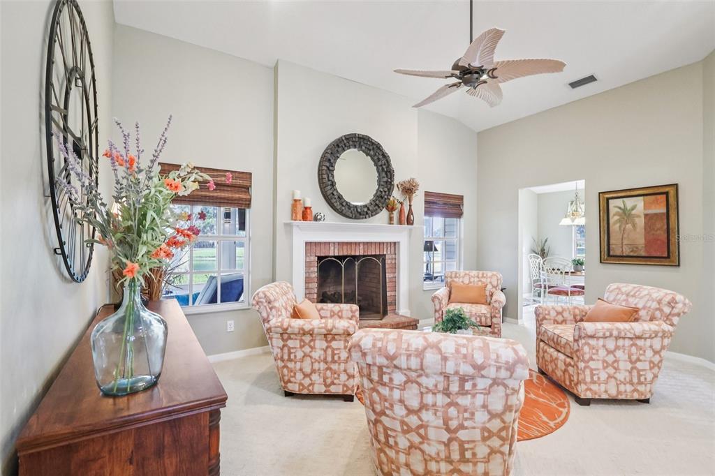 587 Juniper Way Tavares, FL 32778 - Photo 8 of 56 a living room with furniture fireplace and a flat screen tv