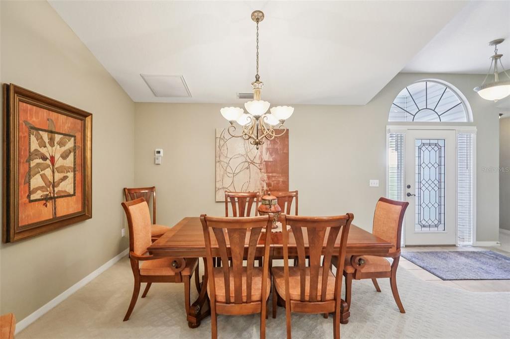 587 Juniper Way Tavares, FL 32778 - Photo 9 of 56 a view of a dining room with furniture and chandelier